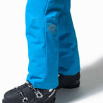 Rossignol Rapide Insulated Pant 2022-2023 - A pair of bright blue ski pants with a logo on the left thigh and two zippered pockets on the side.
