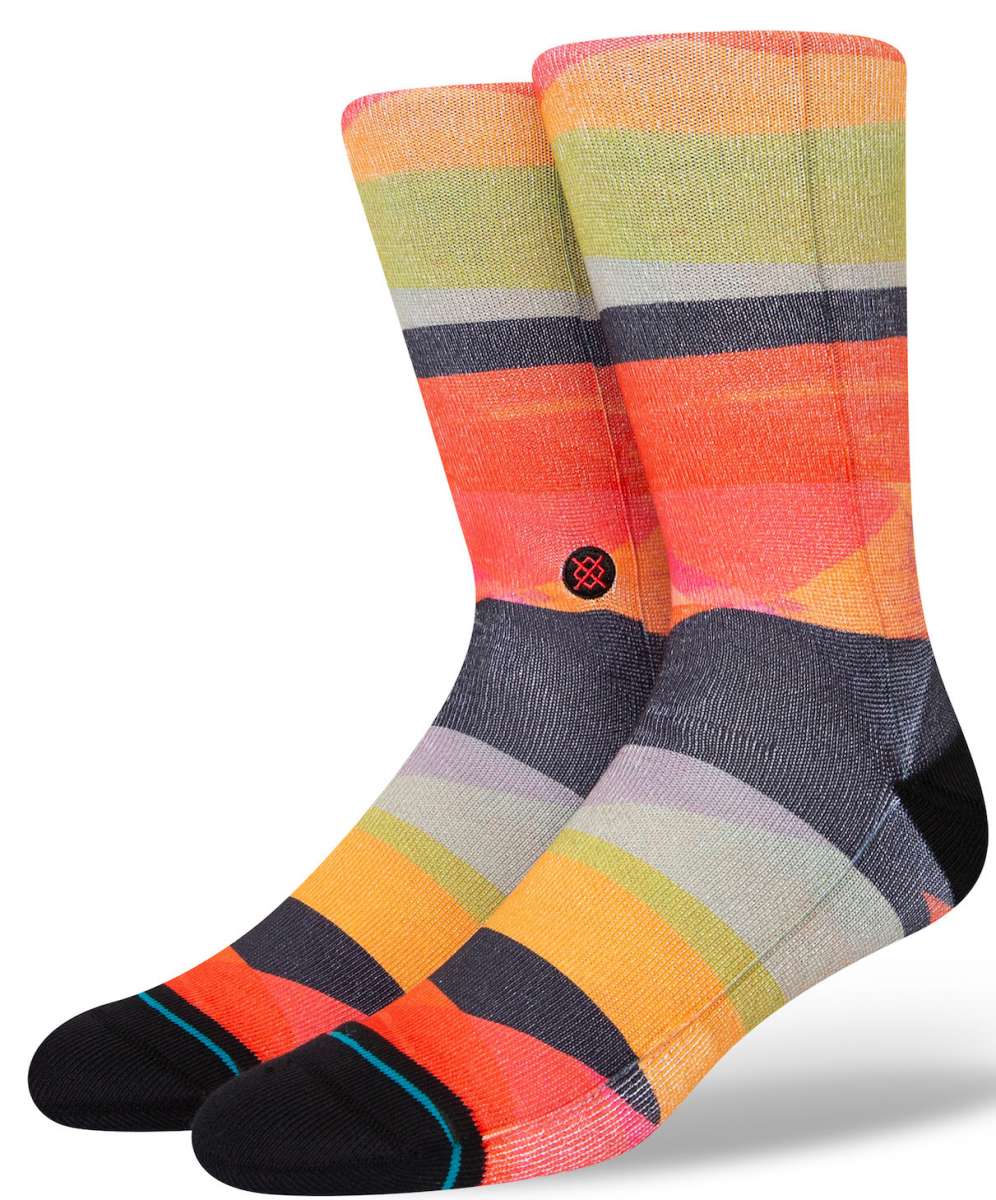 Stance Abstruse Crew Socks 2023 - A pair of crew socks in a vibrant, abstract pattern featuring shades of orange, yellow, green, and gray stripes.