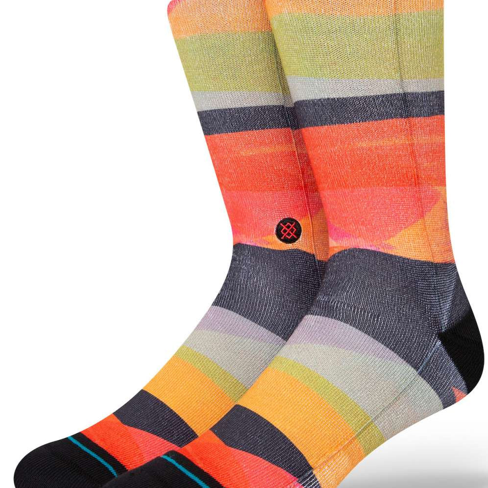 Stance Abstruse Crew Socks 2023 - A pair of crew socks in a vibrant, abstract pattern featuring shades of orange, yellow, green, and gray stripes.