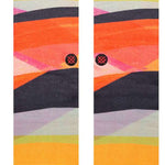 Stance Abstruse Crew Socks 2023 - A pair of crew socks in a vibrant, abstract pattern featuring shades of orange, yellow, pink, and black.