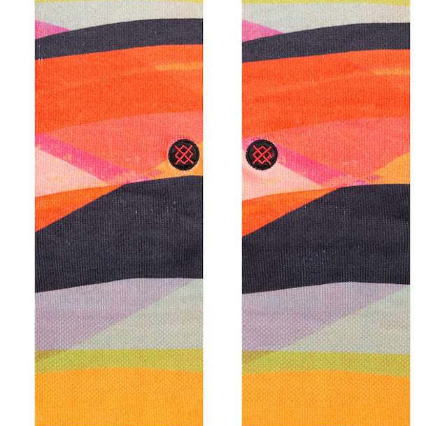 Stance Abstruse Crew Socks 2023 - A pair of crew socks in a vibrant, abstract pattern featuring shades of orange, yellow, pink, and black.