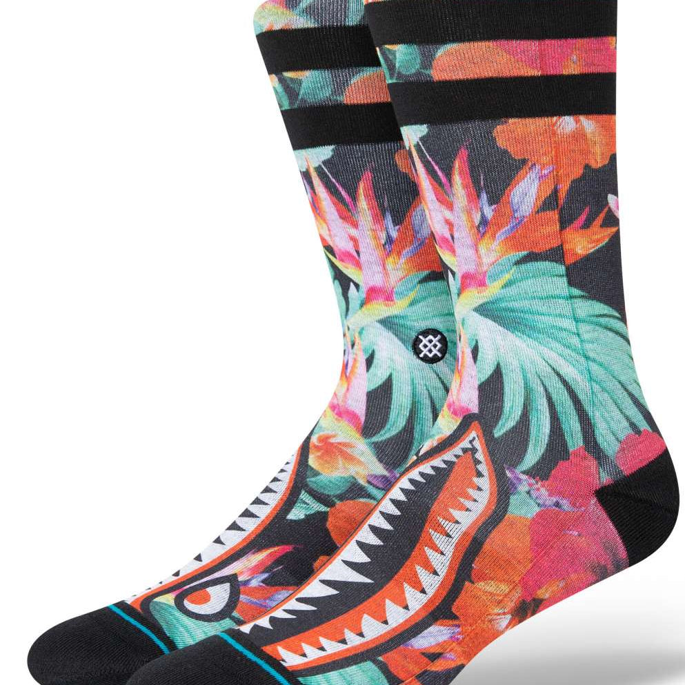 Stance Dorian Crew Cut Socks 2023 - A pair of crew socks with a tropical floral pattern in shades of pink, orange, and green on a black background.