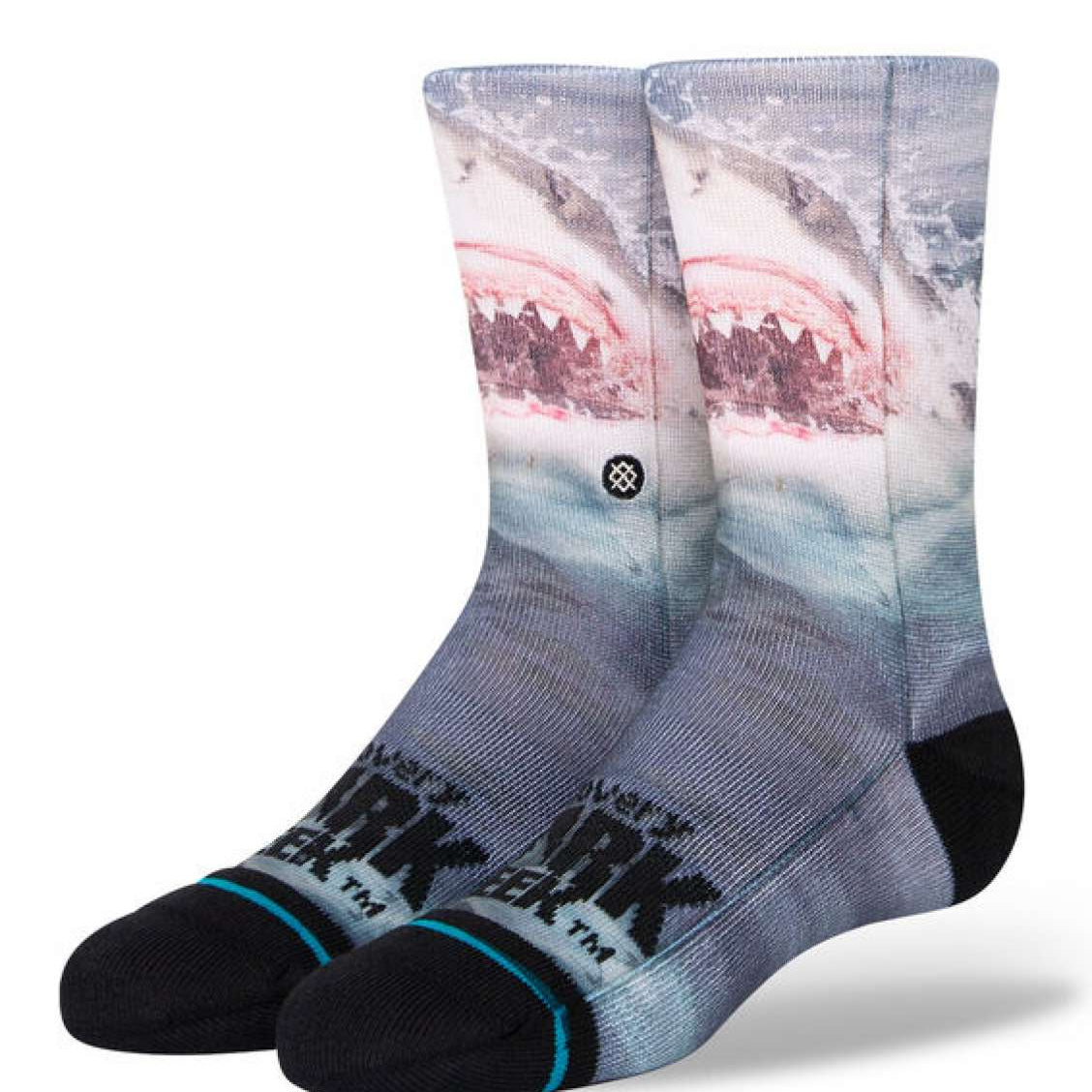 Stance Kids' Shark Week Crew Socks 2023 - A pair of crew socks with a shark design on them, featuring a pink and gray color scheme.