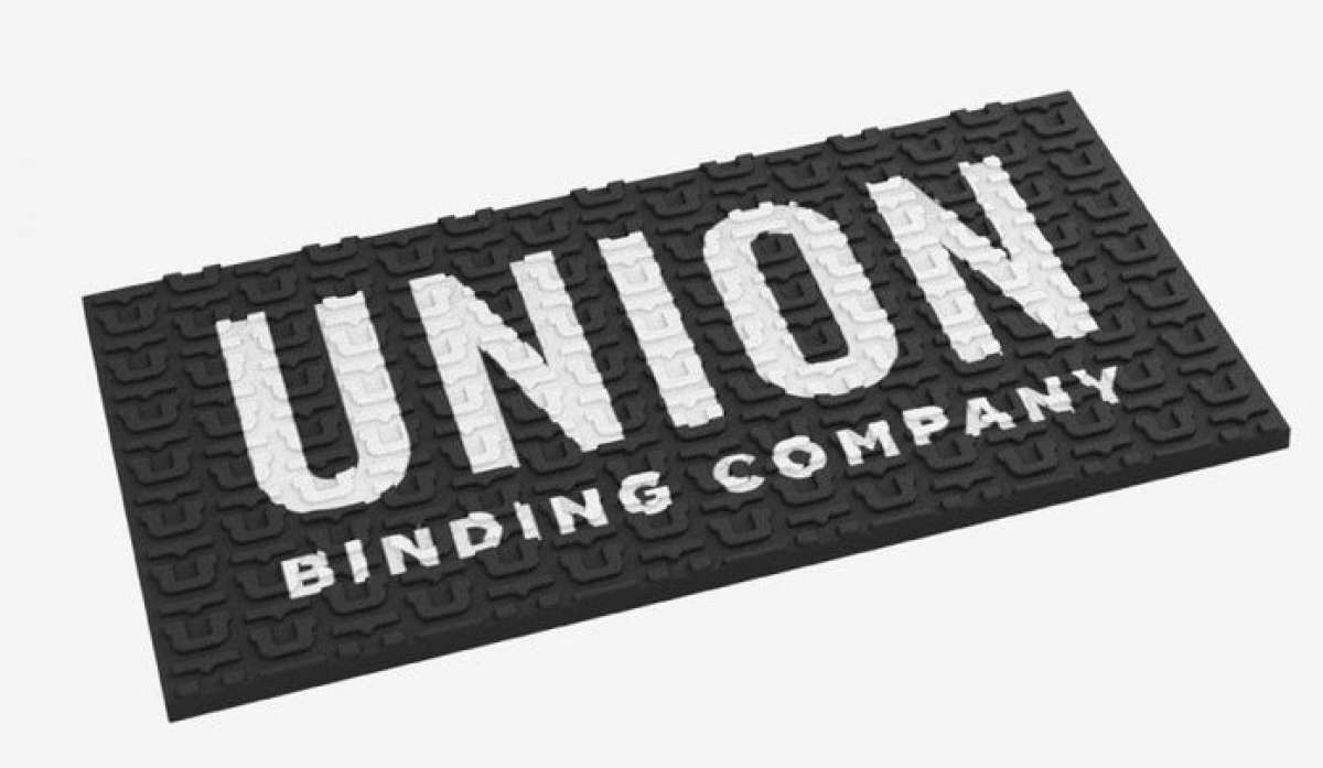Union Surf Stomp Pad - Black surfboard pad with white logo on top.