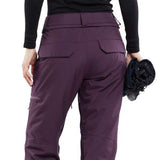 Volcom Women's Knox Insulated GORE-TEX Pant - Black snow pants with a subtle white stripe on the side of the leg, featuring a zippered pocket and adjustable waistband.