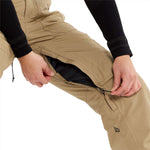 Volcom Women's Knox Insulated GORE-TEX Pant - A pair of khaki-colored snow pants with a black zipper on the left leg, featuring a small black logo near the bottom hem.