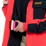 Volcom Longo GORE-TEX Shell Jacket 2024 - A black jacket with a yellow logo on the left chest and silver snaps down the front.