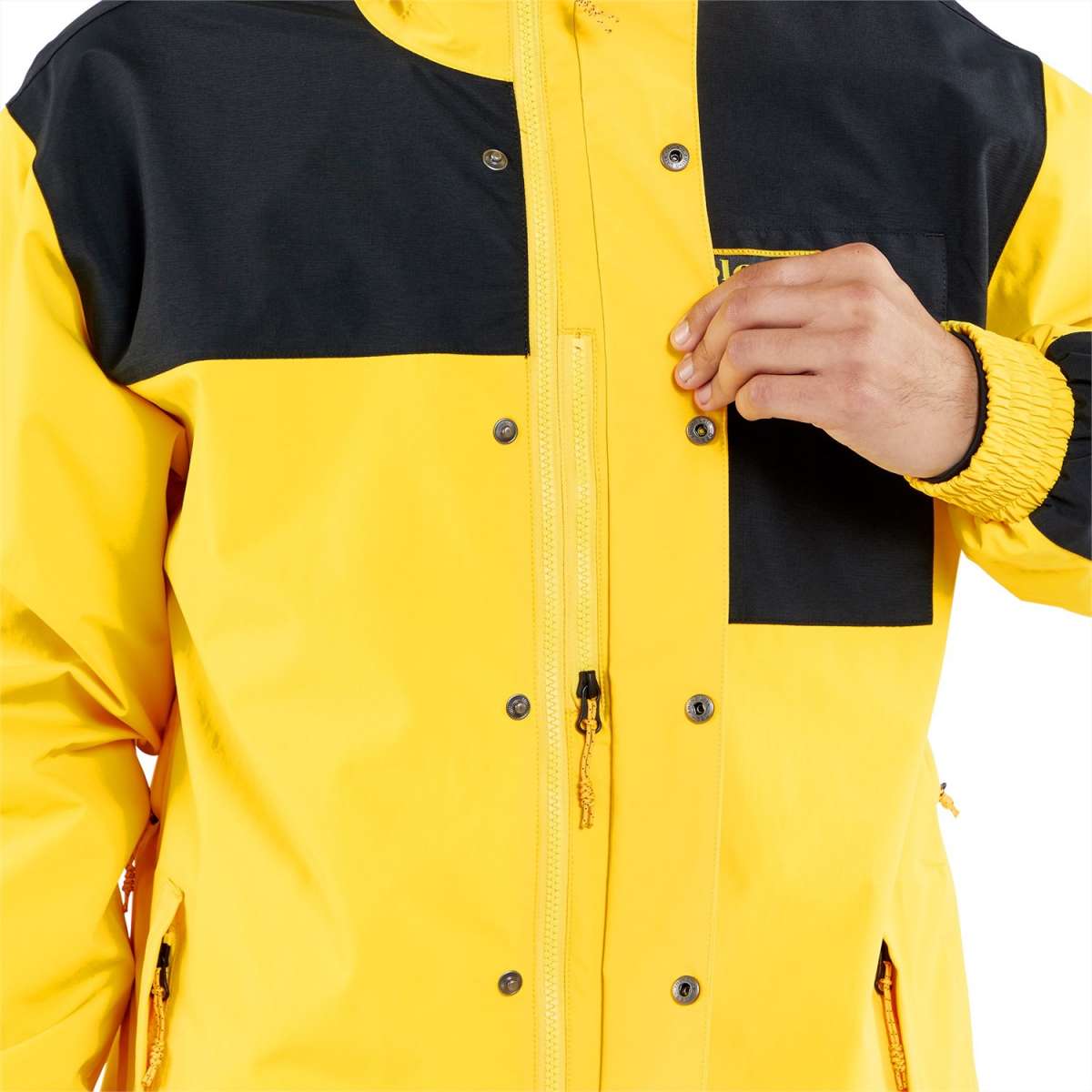 Volcom Longo GORE-TEX Shell Jacket 2024 - A black and yellow jacket with a zippered front, featuring two chest pockets and adjustable cuffs.