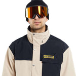 Volcom Longo GORE-TEX Shell Jacket 2024 - A black and tan jacket with a high collar, featuring a small logo on the chest pocket.