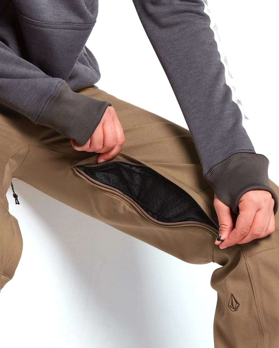 Volcom Women's Species Stretch Pant 2022 - A pair of khaki-colored pants with a zippered fly and two front pockets.