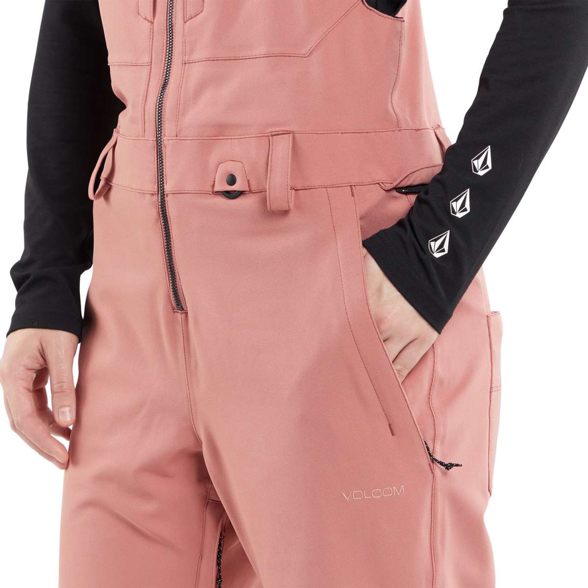 Volcom Women's Swift Bib Overall Pant 2024 - A dusty rose bib overall pant with a black zipper and belt loops on the waistband.