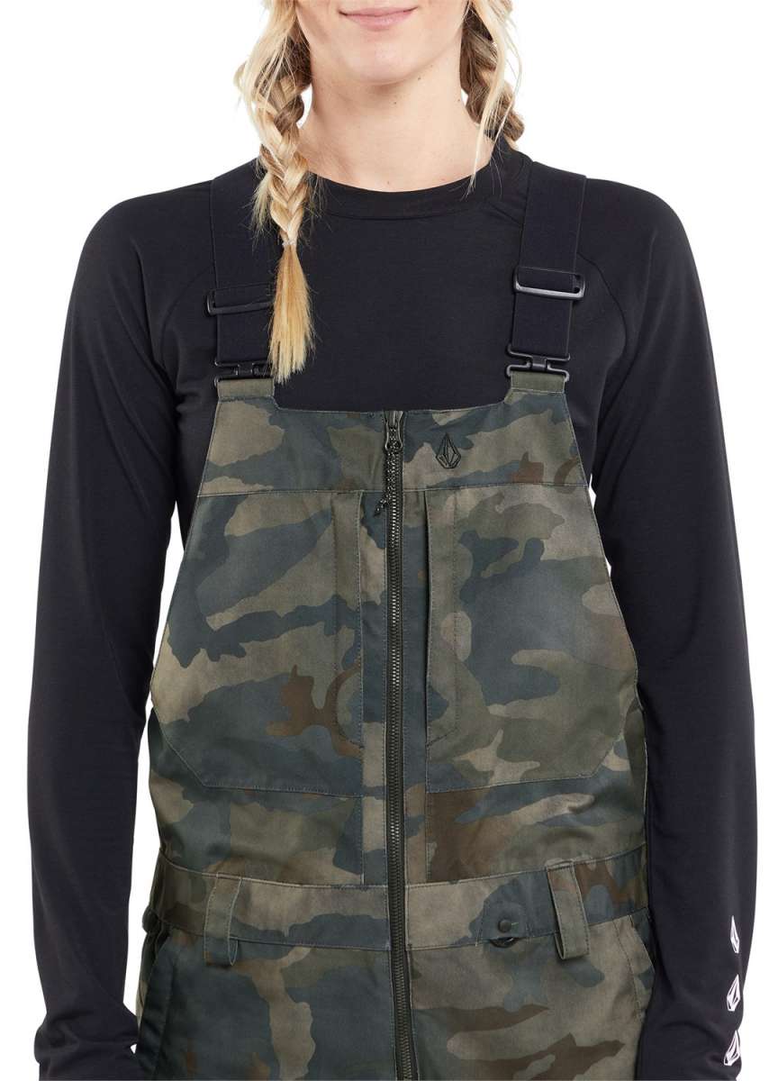 Volcom Women's Swift Bib Overall Pant 2024 - A pair of camouflage bib overalls with a zip front and adjustable straps.