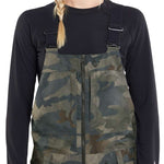 Volcom Women's Swift Bib Overall Pant 2024 - A pair of camouflage bib overalls with a zip front and adjustable straps.