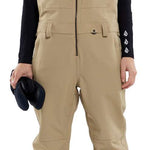 Volcom Women's Swift Bib Overall Pant - Tan bib overalls with zippered front and adjustable straps.