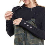 Volcom Women's Swift Bib Overall Pant 2024 - A pair of camouflage-printed bib overalls with adjustable straps and a zippered fly.