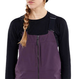 Volcom Women's Swift Bib Overall Pant 2024 - A pair of purple snowboard pants with a zippered front and adjustable straps.