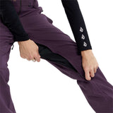 Volcom Women's Swift Bib Overall Pant - A pair of purple snowboard pants with a black zipper and white logo on the left leg.