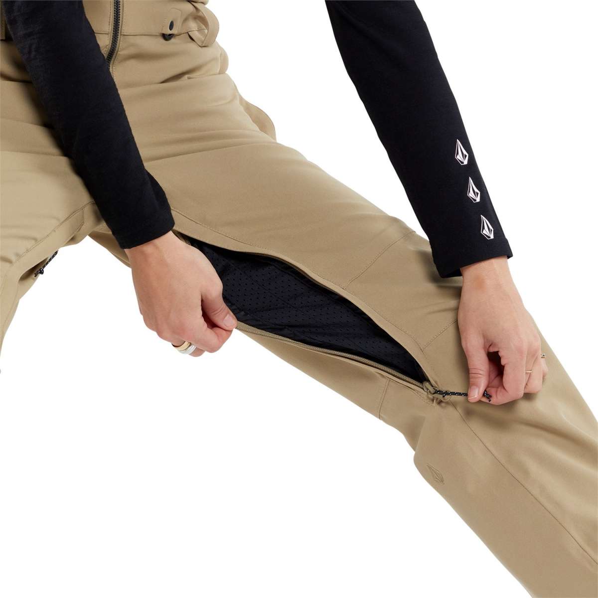 Volcom Women's Swift Bib Overall Pant 2024 - Black bib overalls with white logo on left thigh and black zippered pockets.