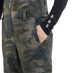 Volcom Women's Swift Bib Overall Pant 2024 - A pair of camouflage bib overalls with a zippered fly and adjustable straps.