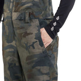 Volcom Women's Swift Bib Overall Pant 2024 - A pair of camouflage bib overalls with a zippered fly and adjustable straps.