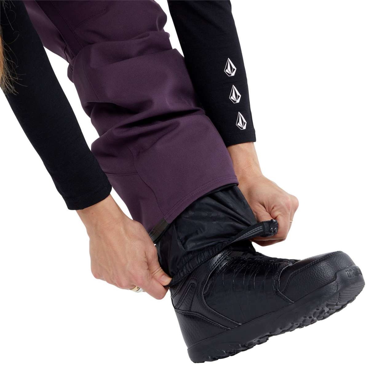 Volcom Women's Swift Bib Overall Pant - A pair of purple snowboard pants with a white logo on the left thigh and black accents around the waistband.