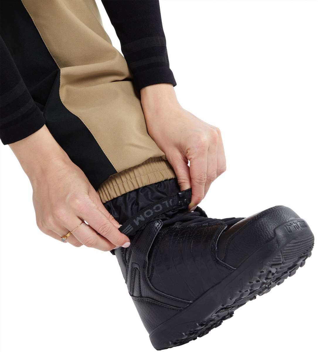 Volcom Women's Wilding Shell Pants 2024 - Black pants with tan stripe down side.