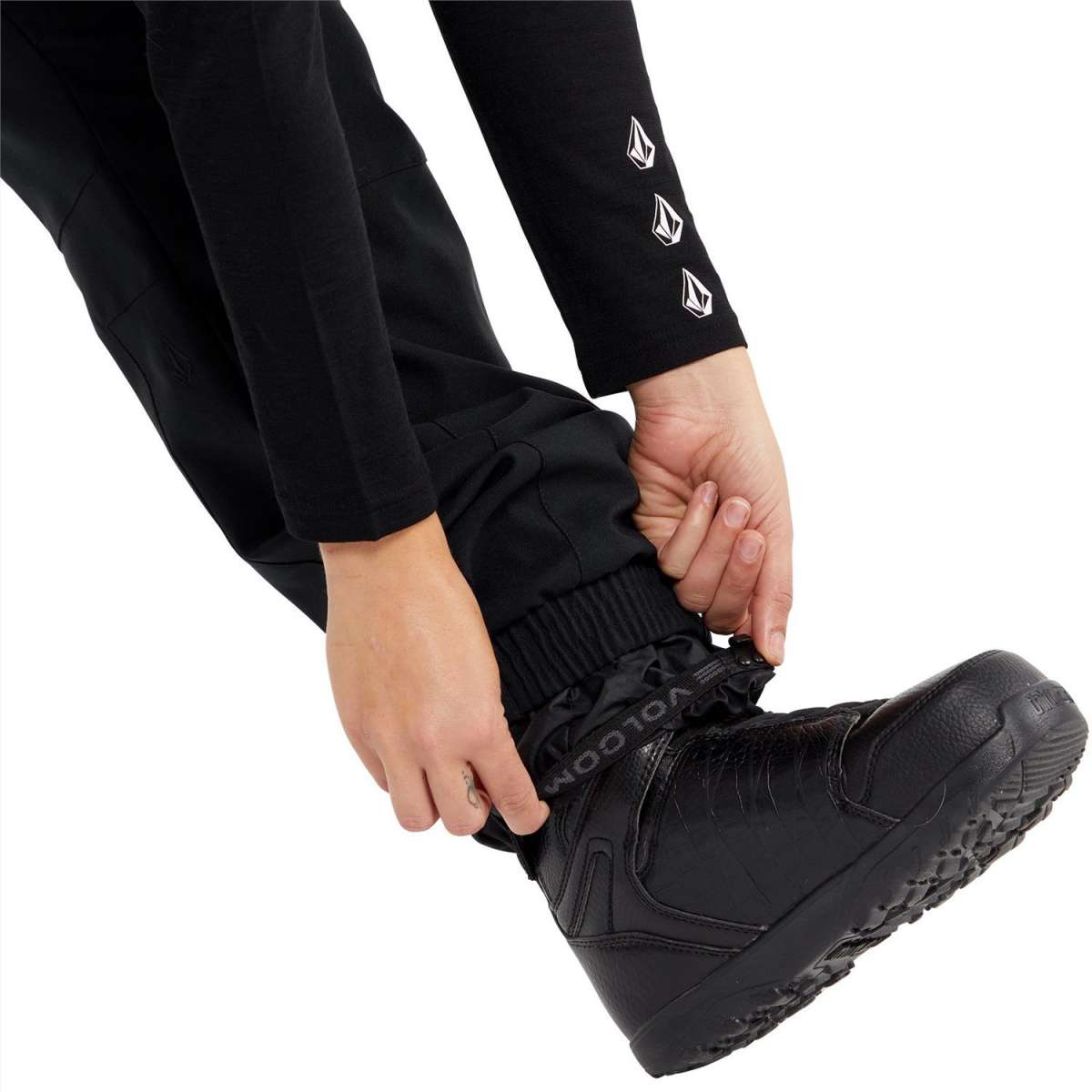 Volcom Women's Wilding Shell Pants 2024 - Black pants with white logo on left thigh and black zipper at ankle.