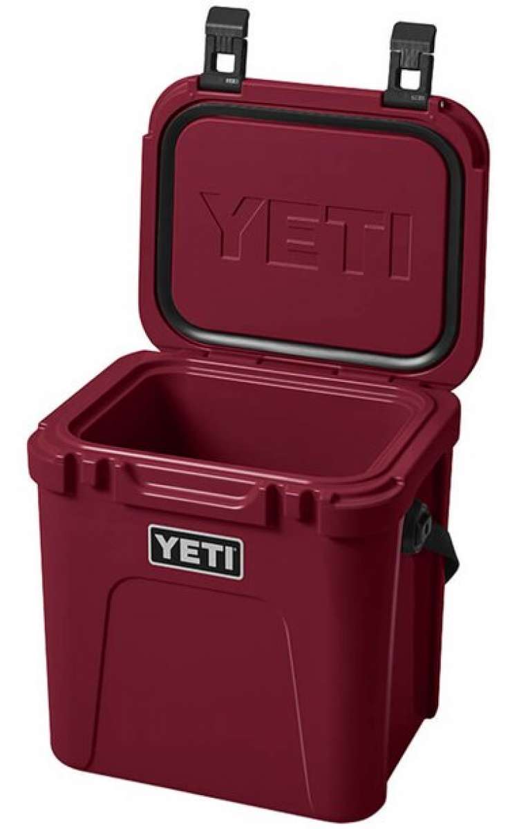 Yeti Roadie 24 Hard Cooler - A red cooler with a handle on top and a latch to secure the lid.