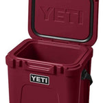 Yeti Roadie 24 Hard Cooler - A red cooler with a handle on top and a latch to secure the lid.