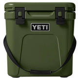 Yeti Roadie 24 Hard Cooler - A green cooler with a handle on top and two latches on the front.