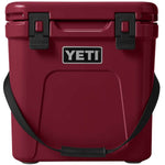 Yeti Roadie 24 Hard Cooler - A red cooler with a handle on top and two latches on the front.