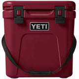 Yeti Roadie 24 Hard Cooler - A red cooler with a handle on top and two latches on the front.