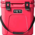 Yeti Roadie 24 Hard Cooler - A red cooler with a handle on top and two latches on the front.