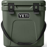 Yeti Roadie 24 Hard Cooler - A dark green cooler with a handle on top and two latches on either side of it.