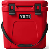 Yeti Roadie 24 Hard Cooler - A red cooler with a handle on top and two latches on the front.