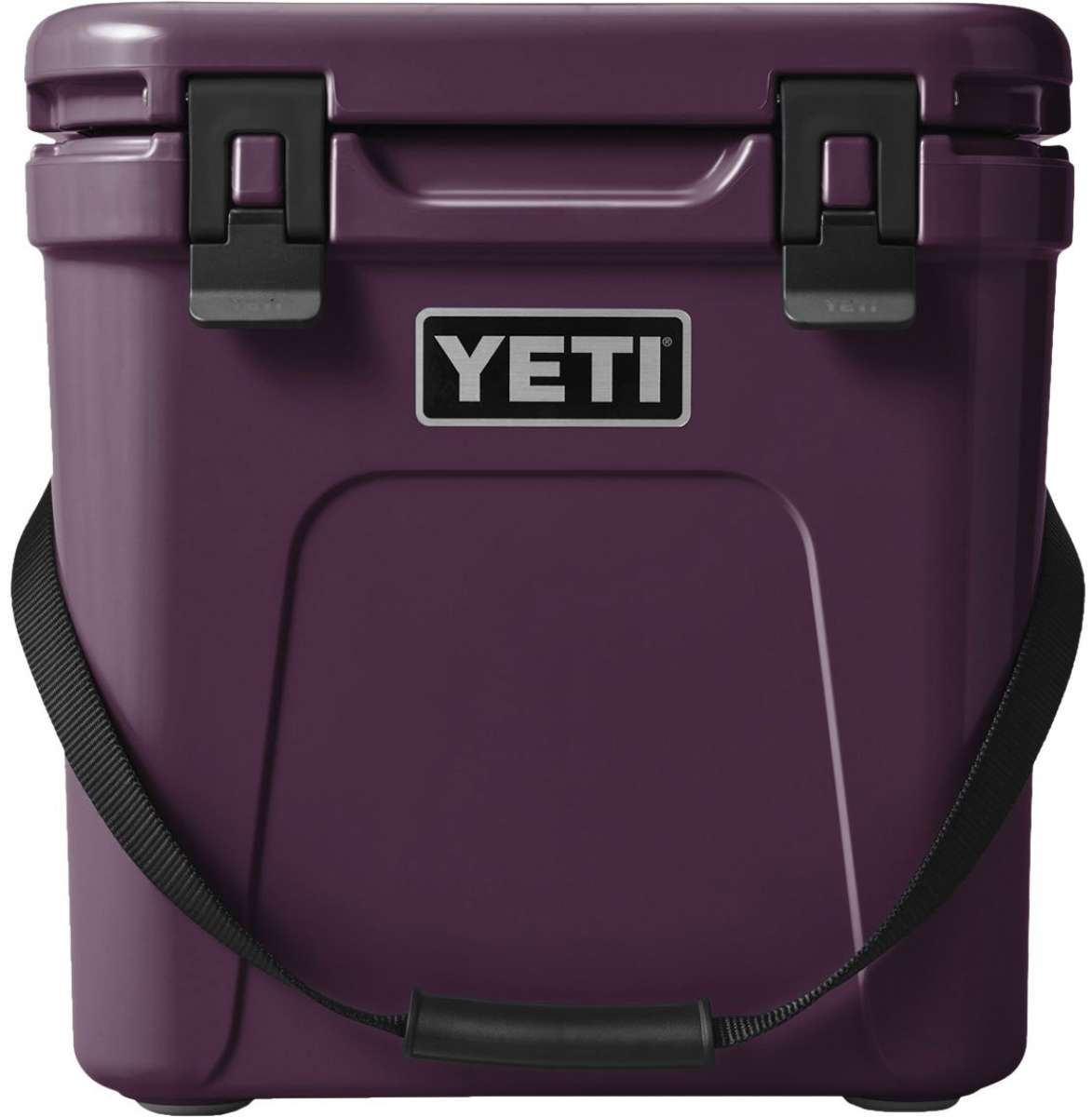 Yeti Roadie 24 Hard Cooler - A compact, portable cooler with a sleek design and a silver handle on top.