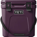 Yeti Roadie 24 Hard Cooler - A compact, portable cooler with a sleek design and a silver handle on top.