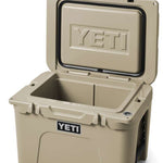 Yeti Tundra 35 Hard Cooler - A tan-colored cooler with a rectangular shape and a handle on top, featuring the word "YETI" embossed in silver letters on its front side.