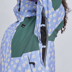 Airblaster Women's Freedom Insulated Suit 2024 - A light blue snowsuit with a repeating pattern of white daisies and yellow centers, featuring black zippers and a black logo on the chest.