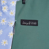 Airblaster Women's Freedom Insulated Suit 2024 - A light blue snowsuit with a repeating pattern of white flowers and yellow centers.