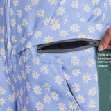 Airblaster Women's Freedom Insulated Suit 2024 - A light blue snowsuit with a repeating pattern of white daisies and yellow centers, featuring a zipper on the front.