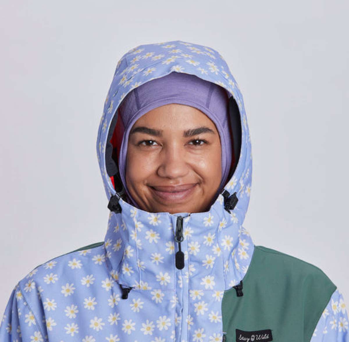 Airblaster Women's Freedom Insulated Suit 2024 - A light blue snowsuit with a daisy pattern and black accents.