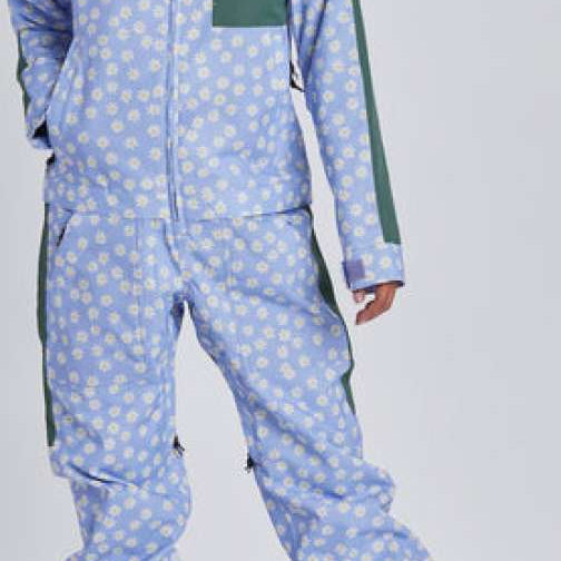 Airblaster Women's Freedom Insulated Suit 2024 - A light blue snowsuit with a white floral pattern and green accents on the shoulders, chest, and side panels.