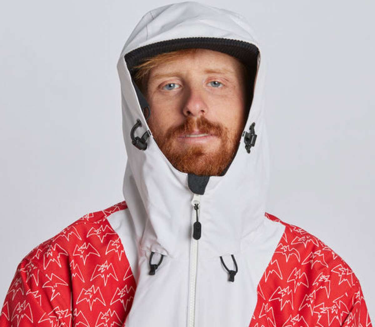 Airblaster Freedom Shell Pullover 2024 - A red, black and white snowboarding jacket with a hood featuring a graphic of a man riding a snowboard on it.