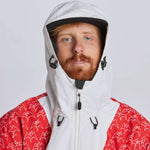 Airblaster Freedom Shell Pullover 2024 - A red, black and white snowboarding jacket with a hood featuring a graphic of a man riding a snowboard on it.