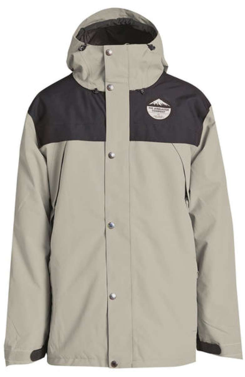 Airblaster Guide Shell Jacket 2024 - A tan-colored jacket with a black chest panel and hood, featuring a logo on the left side of the chest.