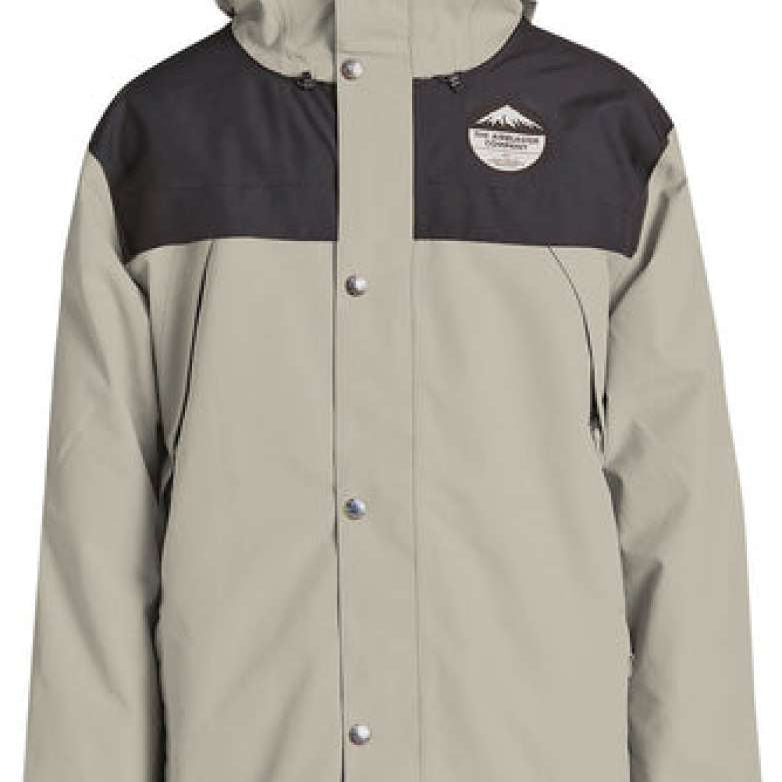 Airblaster Guide Shell Jacket 2024 - A tan-colored jacket with a black chest panel and hood, featuring a logo on the left side of the chest.