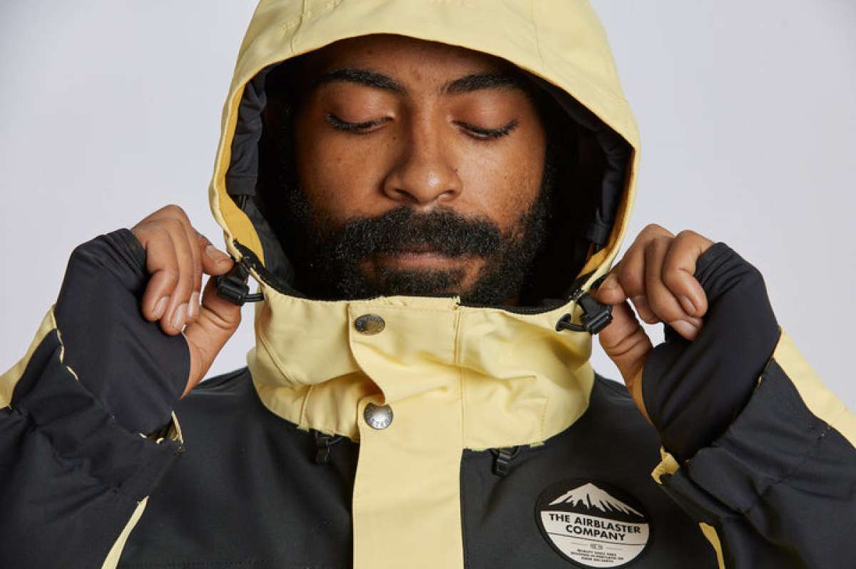 Airblaster Guide Shell Jacket 2024 - A black jacket with a white logo on the left chest and yellow accents along the zipper, sleeve cuffs, and hood.