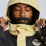 Airblaster Guide Shell Jacket 2024 - A black jacket with a white logo on the left chest and yellow accents along the zipper, sleeve cuffs, and hood.