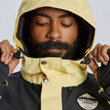 Airblaster Guide Shell Jacket 2024 - A black jacket with a white logo on the left chest and yellow accents along the zipper, sleeve cuffs, and hood.